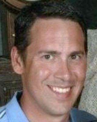 Headshot of a smiling man