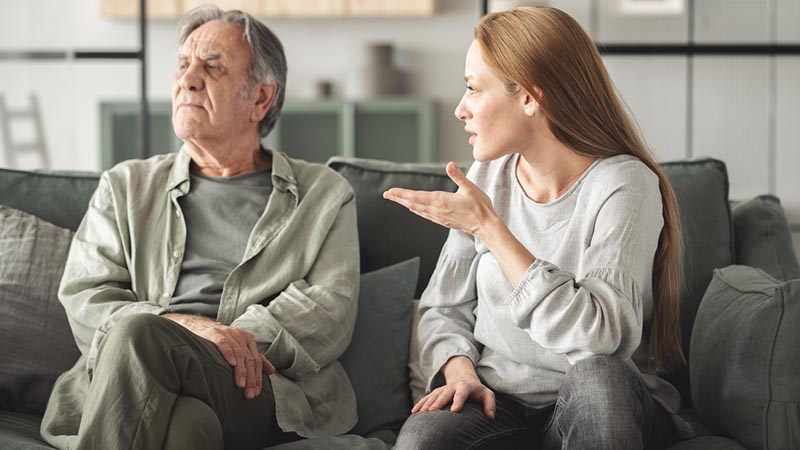 Woman arguing with older man, illustrating family conflict and communication breakdown
